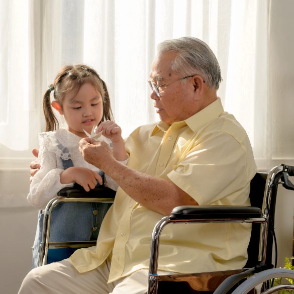 elderly man on wheelchair with a child